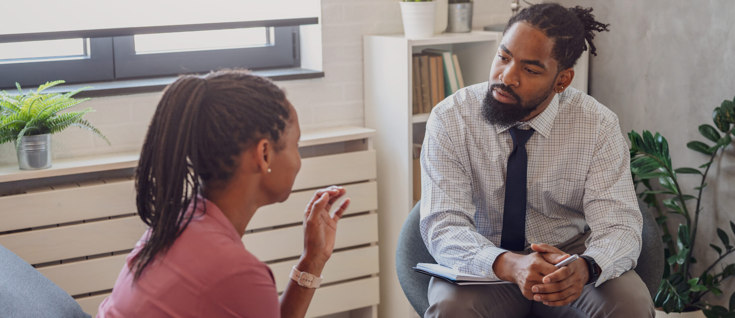 Young professional man discussing with young woman.