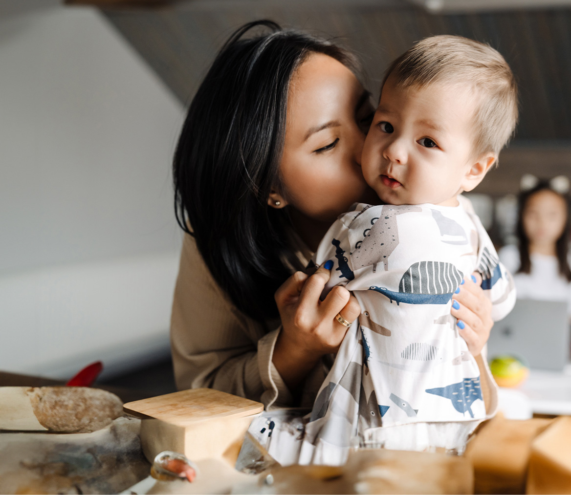 Young mother with baby on table.